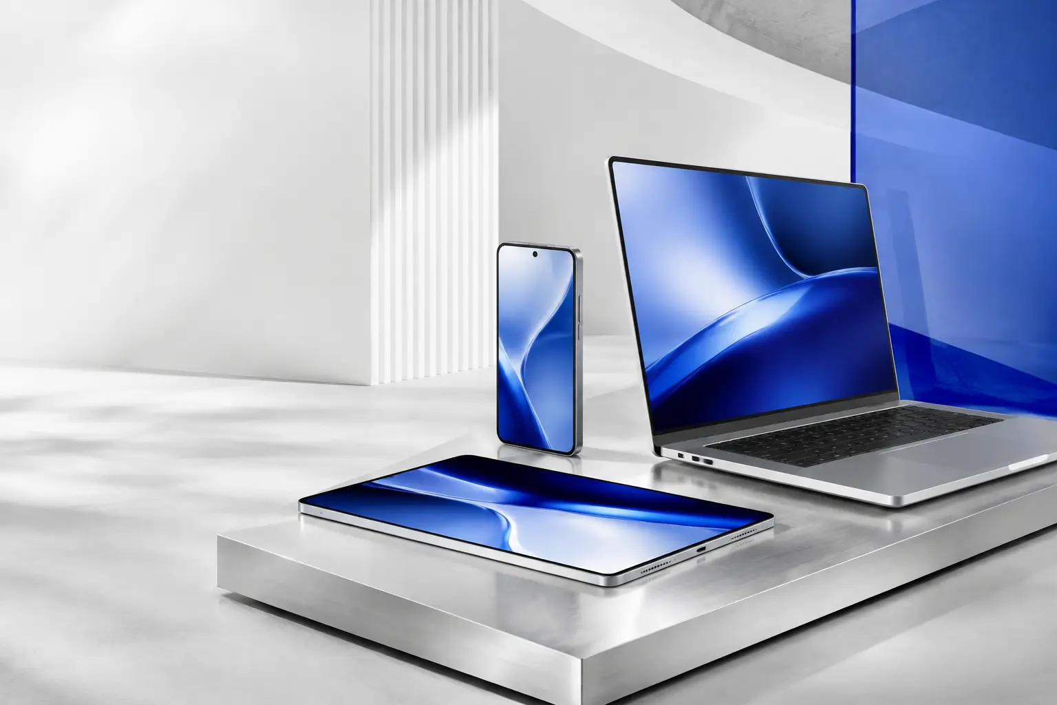 A smartphone, tablet and laptop in a bright studio
